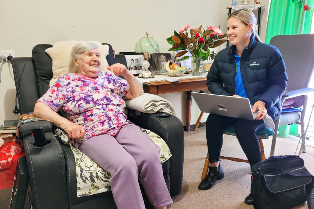 Clinician and client sitting next to each other during an assessment