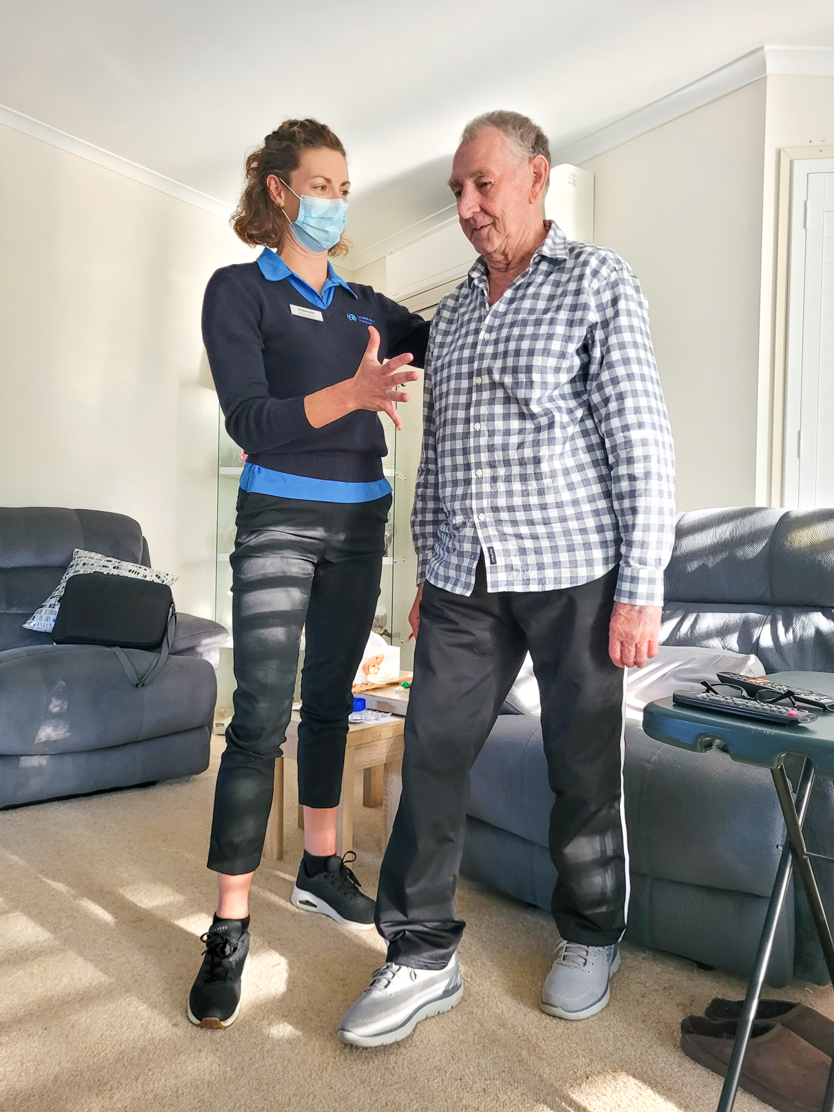 Physiotherapist and aged care client doing balance exercises