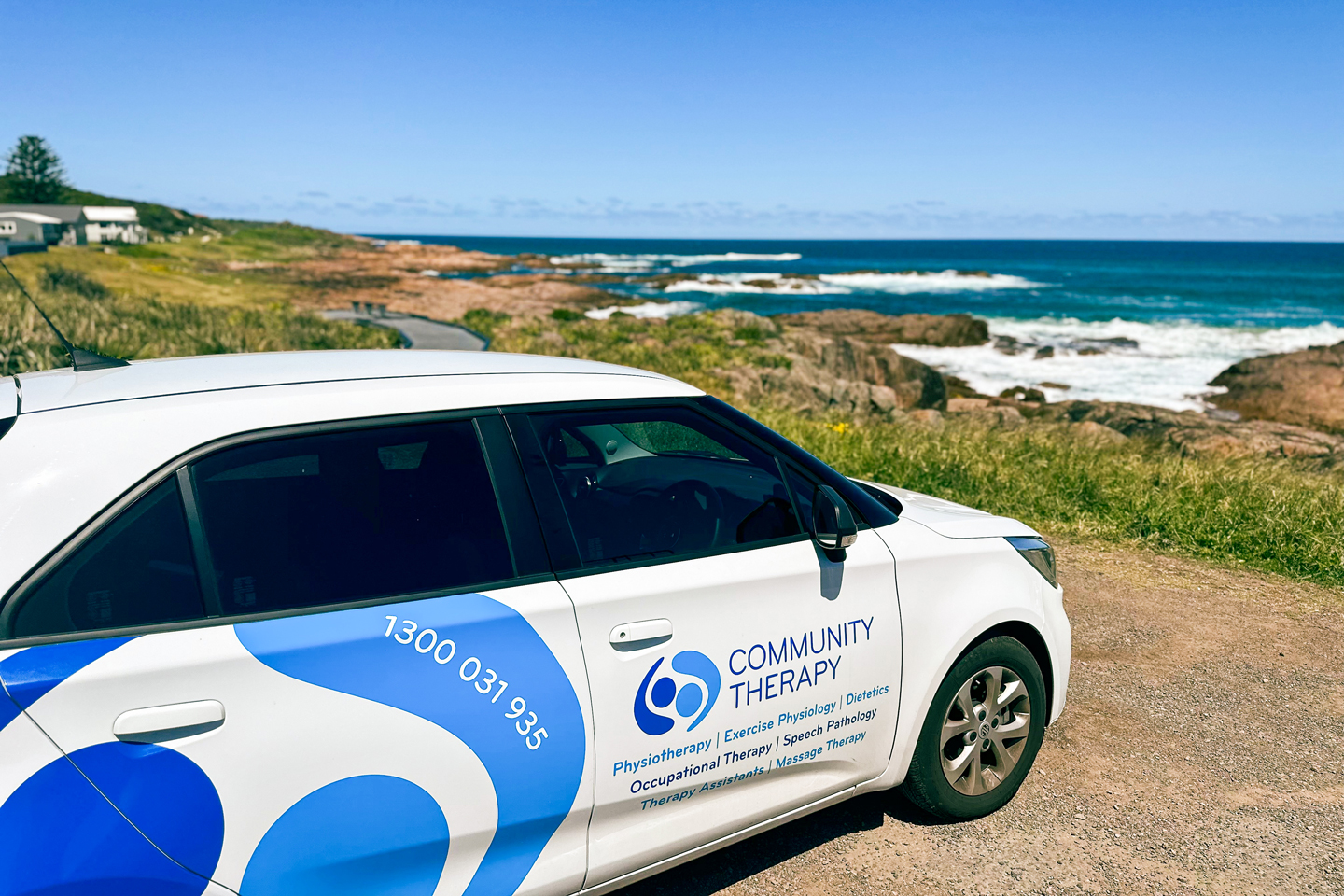 Community Therapy branded car with a view of Anna Bay